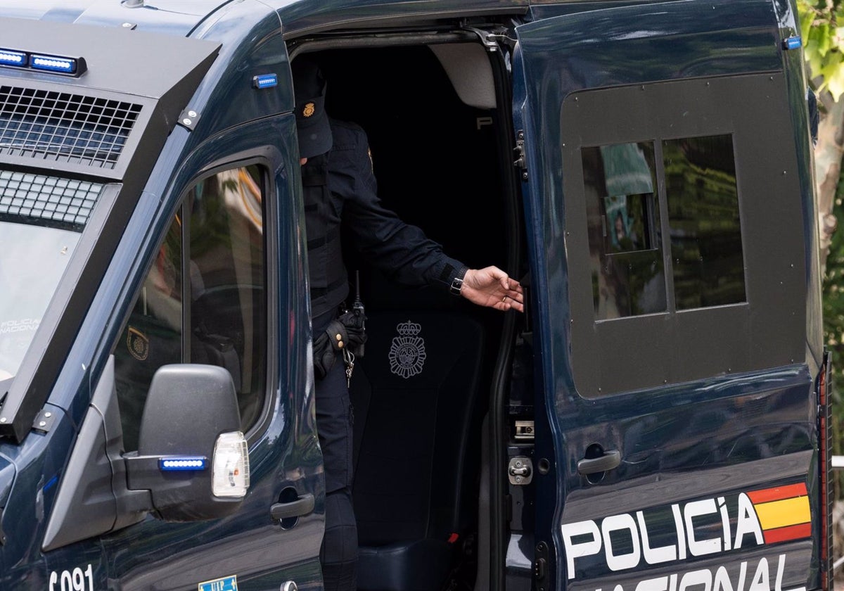 Un agente de la UIP de Policía Nacional cierra la puerta de un furgón policial.