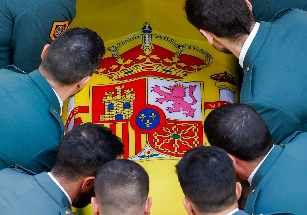 Compañeros del agente del GEAS fallecido en Barbate cargan su féretro en el funeral oficiado en Cádiz.