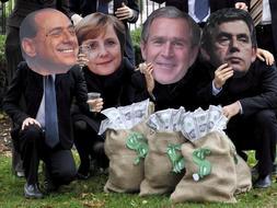 Varias personas posan con caretas del primer ministro italiano, Silvio Berlusconi, la canciller alemana, Angela Merkel, el presidente de Estados Unidos, George W.Bush, y el primer ministro británico, Gordon Brown, durante una protesta en contra de la cumbre del G-20. /Reuters