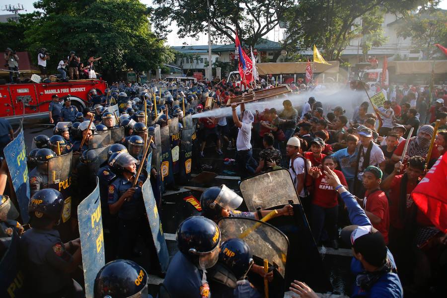 En Filipinas, los manifestantes y la policía se han enfrentado a su paso por la embajada en Manila. 