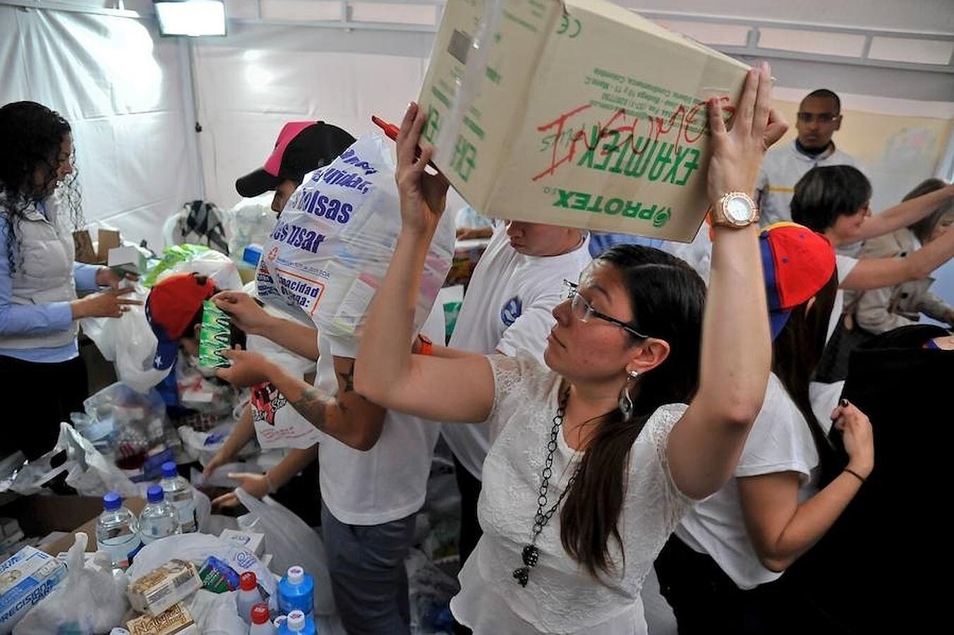 Bolsas y cajas con productos de primera necesidad son organizados en una improvisada tienda en Bogotá. 