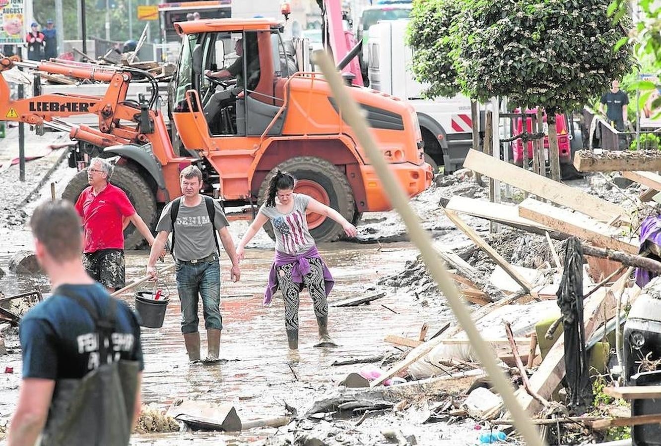 Las grúas ayudan a retirar los escombros de la calle. 