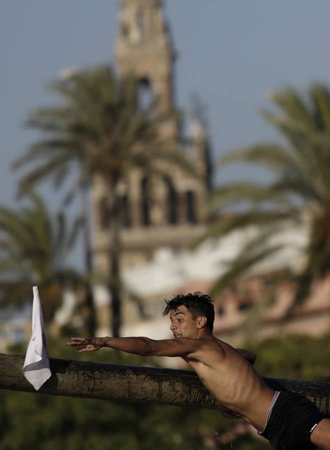 Los participantes deben caminar sobre el poste, previamente embadurnado con grasa resbaladiza, evitando caer al agua, hasta alcanzar el banderín del otro extremo