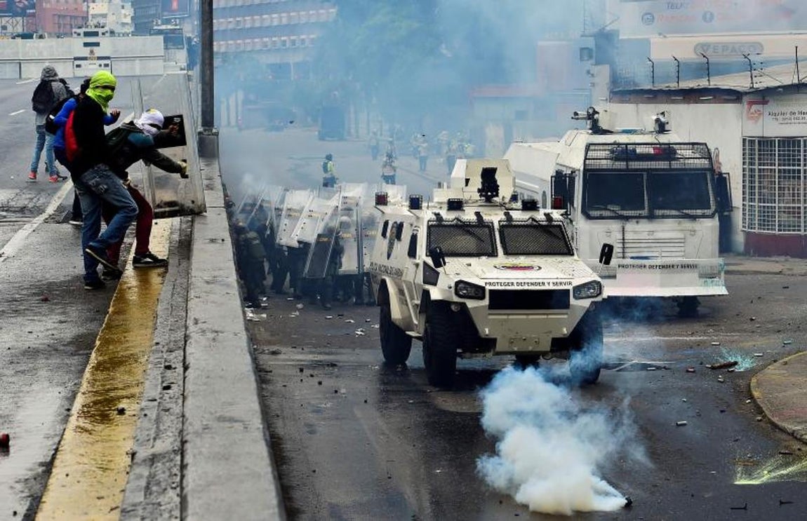 La policía antidisturbios toma posición mientras choca con manifestantes durante la llamada «madre de todas las marchas». 