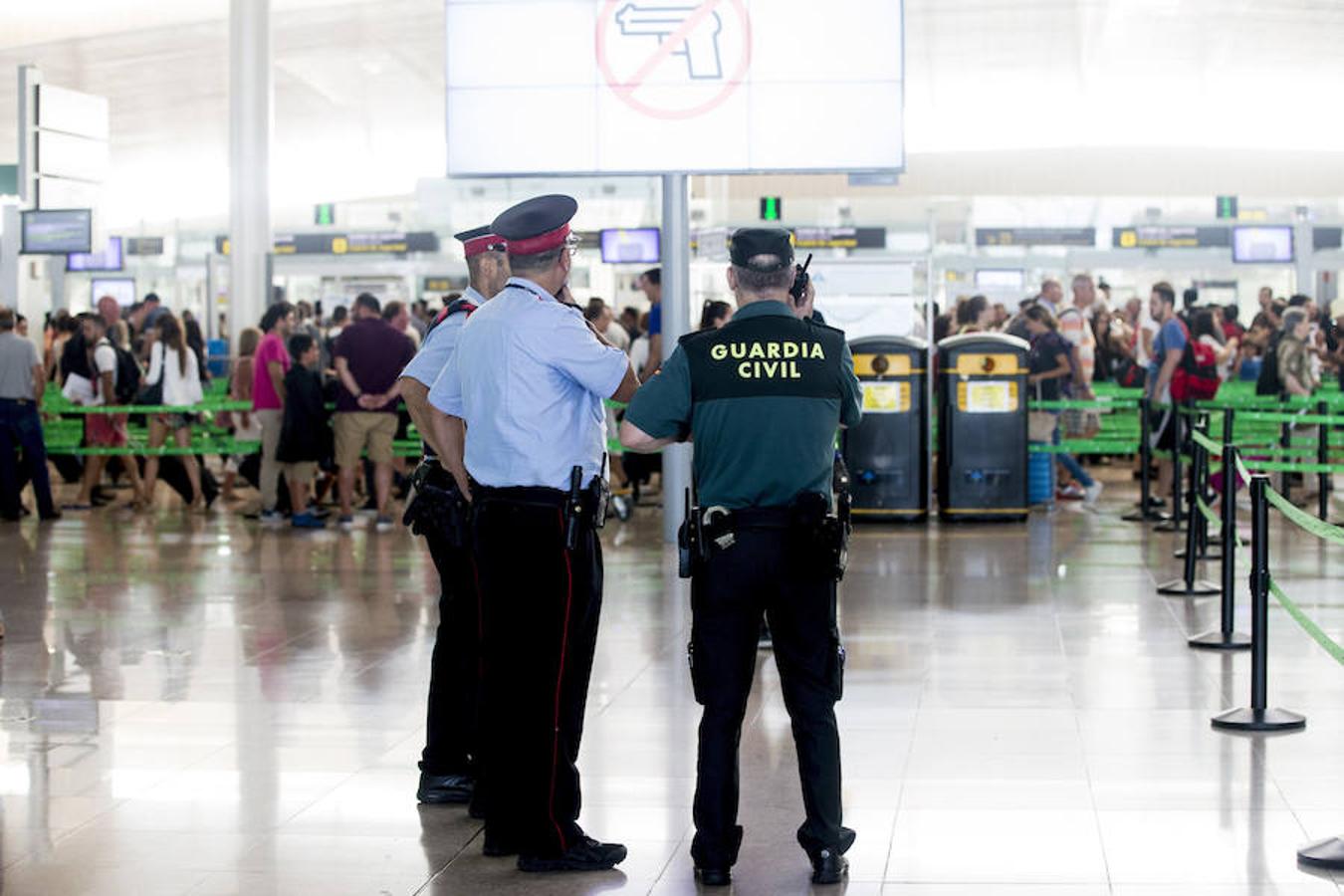 La Guardia Civil custodian los accesos a las puertas de embarque en el aeropuerto de Barcelona. 