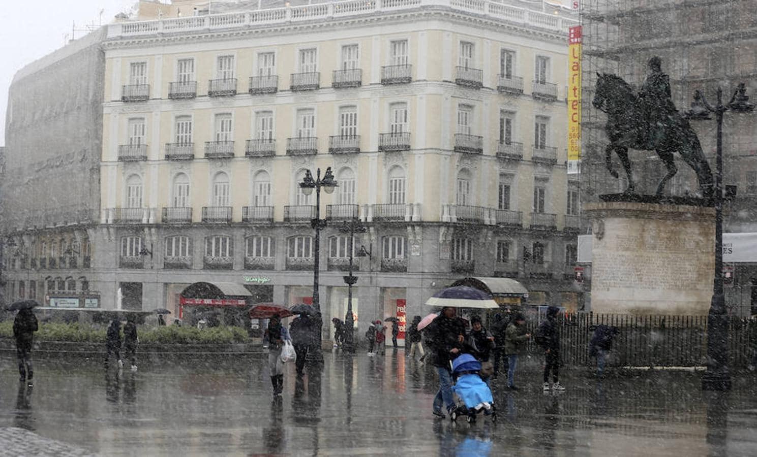 La nieve también cae sobre la Plaza del Sol de Madrid.. 