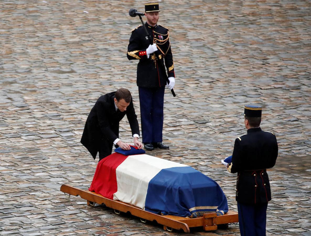 El presidente francés, Emmanuel Macron, coloca la insignia de la Legión de Honor durante la ceremonia de Estado celebrada en la Explanada de los Inválidos, en París, este miércoles. 