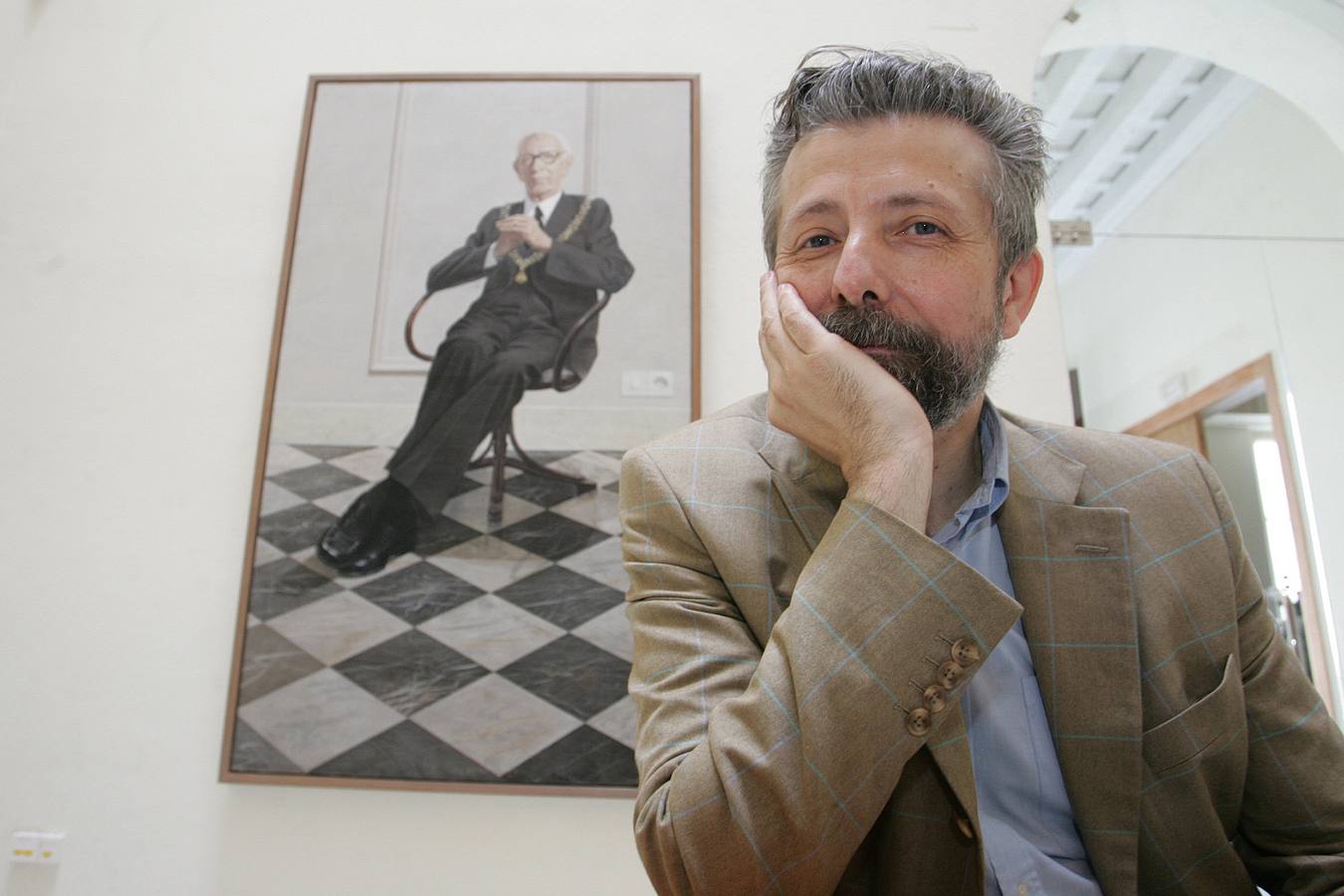 El pintor Hernán Cortés con un retrato de Pemán al fondo