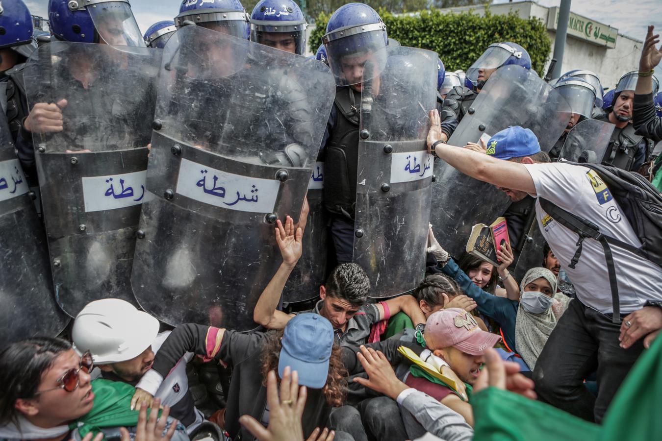 Enfrentamientos policiales. El fotógrafo argelino Farouk Batiche ha ganado el primer premio en la categoría «Spot News Singles» con esta foto titulada «Choque con la policía durante una manifestación antigubernamental» para la Agencia de Prensa Alemana DPA. Muestra a estudiantes argelinos enfrentándose con la policía antidisturbios argelina durante una manifestación antigubernamental.