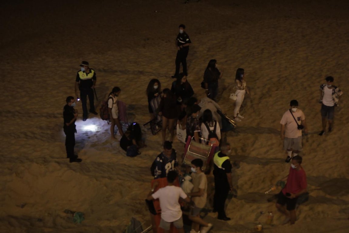 FOTOS: Unos 1.000 jóvenes son desalojados de la playa en Cádiz cuando hacían botellón por San Juan