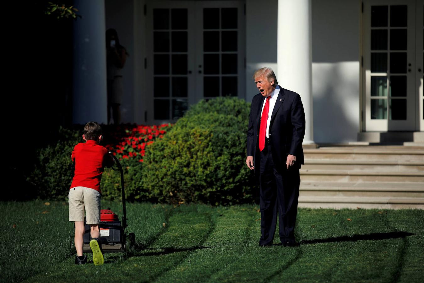 Trump saluda a Frank Giaccio, un niño de 11 años que corta el césped del Jardín de las Rosas de la casa Blanca el 15 de septiembre de 2017.. 