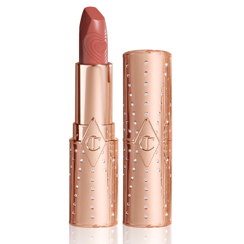 Barra de labios Charlotte Tilbury Look of Love Lipstick Nude Romance. Un nude melocotón, con acabado satinado, que favorece a todas las mujeres y que no pasa de moda. Nude Romance de Charlotte Tilbury nutre los labios intensamente gracias a los extractos de achiote, dejándolos más voluminosos y perfectos por los pigmentos difusores de luz. Una barra de labios en un bonito tubo recargable (35 €).