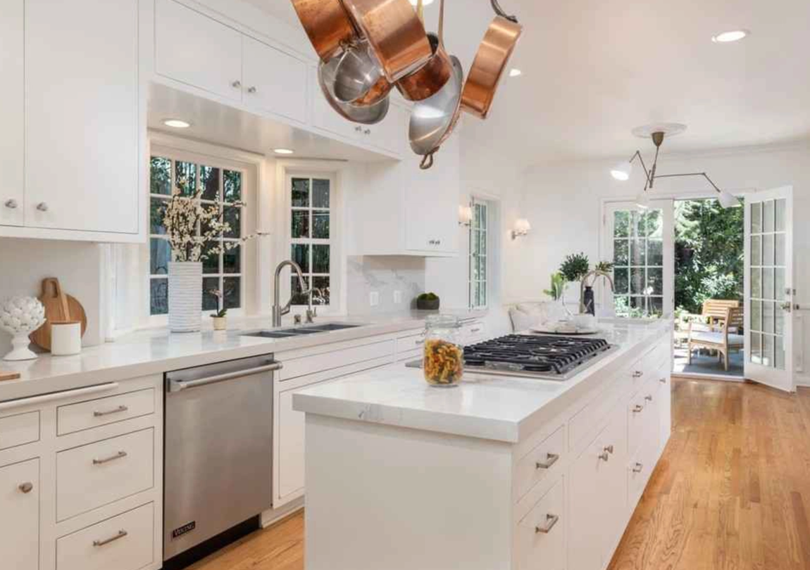 Así es la mansión de Los Feliz de DiCaprio. La cocina del chef incluye gabinetes de madera en blanco, encimeras de mármol, electrodomésticos de acero inoxidable de alta gama y una isla con espacio extra de almacenaje, fregadero y fuegos para cocinar.