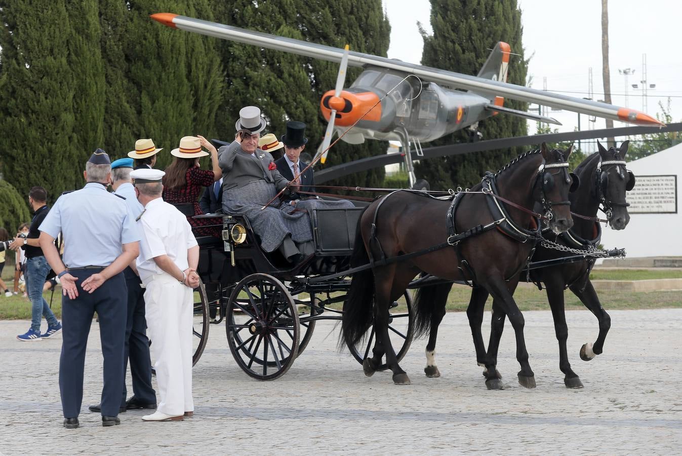 Izado de bandera en Tablada, con los carruajes participantes en el primer paseo por la ciudad.