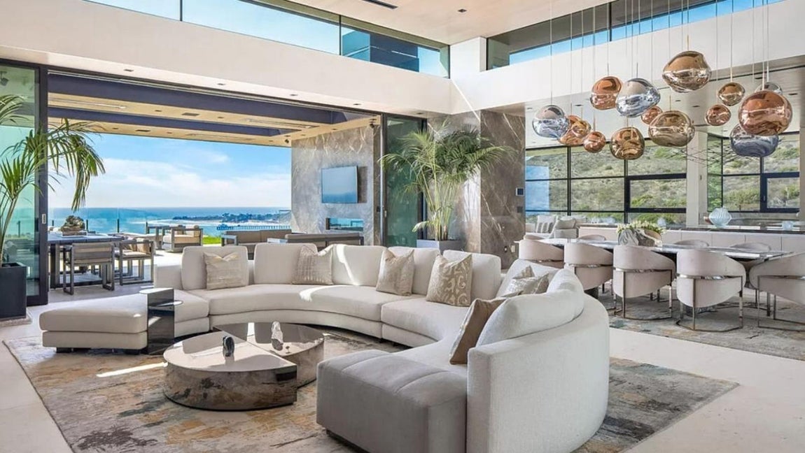 Así es por dentro la mansión más lujosa de Malibú. El salón principal comunica con el jardín que a su vez posee un gran porche en el que poder celebrar todo tipo de reuniones en su interior, desde almuerzos a fiestas.