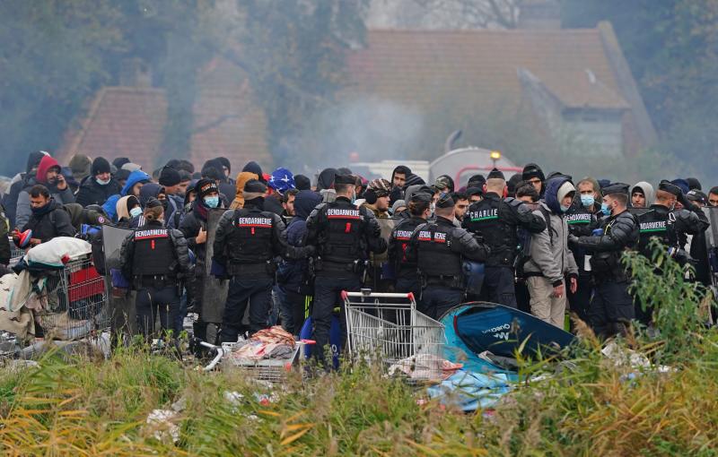 Los gendarmes franceses explican a los inmigrantes que deben de abandonar el lugar. 