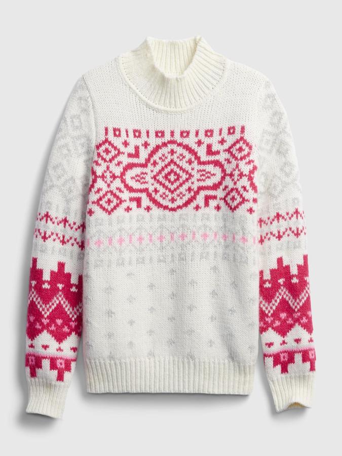 Gap - Jerséis navideños para lucir estas fiestas. Jersey de lana con cuello perkins y detalles navideños en rosa y rojo, de Gap. Un diseño que encaja a la perfección en los ‘total look white’ para ir a la nieve y que se puede amortizar en las próximas temporadas. Precio: 74,95€.