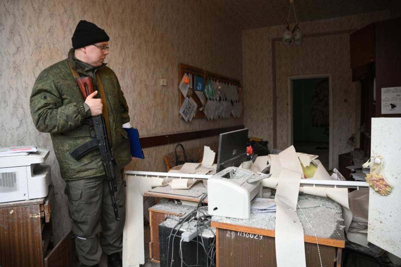 Un miembro de la milicia ucraniana observa los daños en el aula de un colegio en Horlivka. 