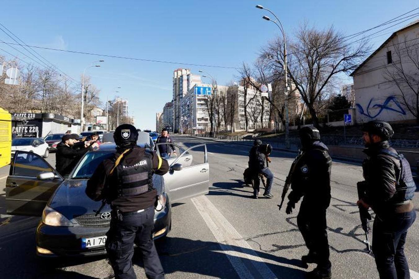 Policías cachean a un grupo de personas a las que han parado en Kiev. 