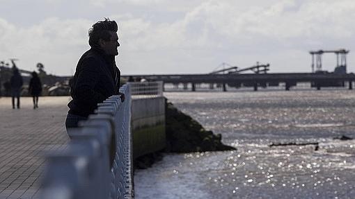 Un hombre vislumbra la Ría de Huelva desde el nuevo paseo