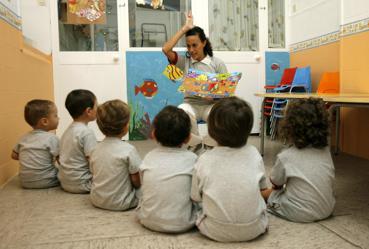 Un grupo de niños y su maestra en una guardería el primer día de clase