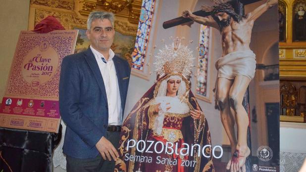 El fotógrafo Rafael Sánchez posa junto a su cartel anunciador de la Semana Santa de Pozoblanco