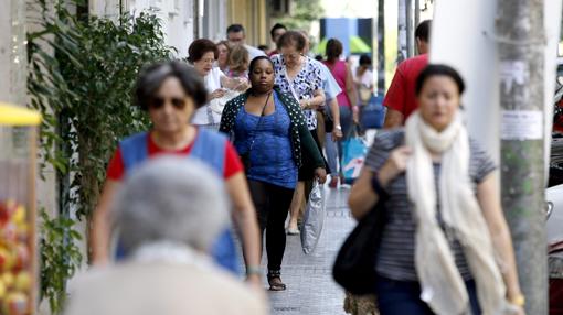 Viandantes por una calle del popular barrio de Ciudad Jardín en Córdoba