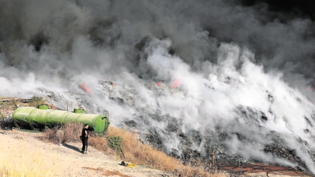 Un bombero ante una densa cortina de humo en los primeros días del incendio de Recicor