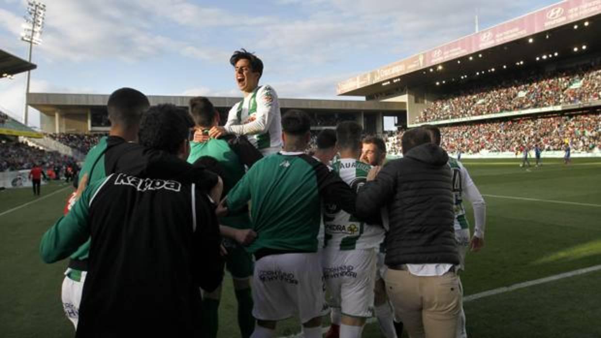 Aguado celebra encima de sus compañeros con el campo lleno el gol del triunfo ante el Lorca