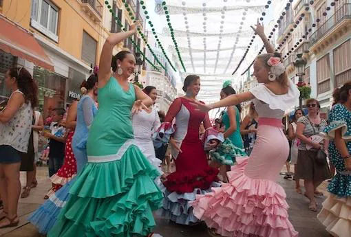 Dos mujeres bailando en Calle Larios durante la Feria de Málaga 2018