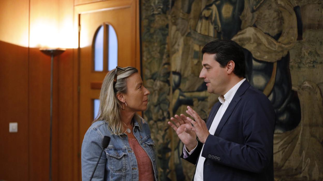 Isabel Albás y José María Bellido hablan en la sala de comisiones