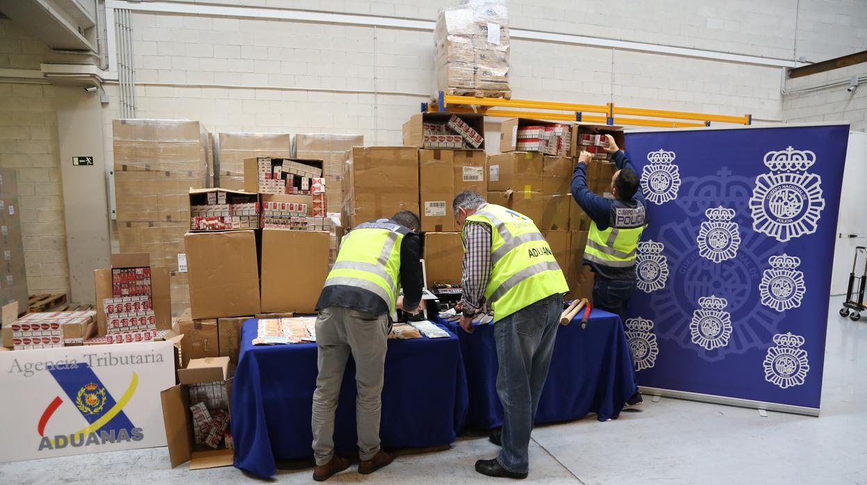 Agentes de la Policía Nacional y Aduanas con el material incautado sobre contrabando de tabaco