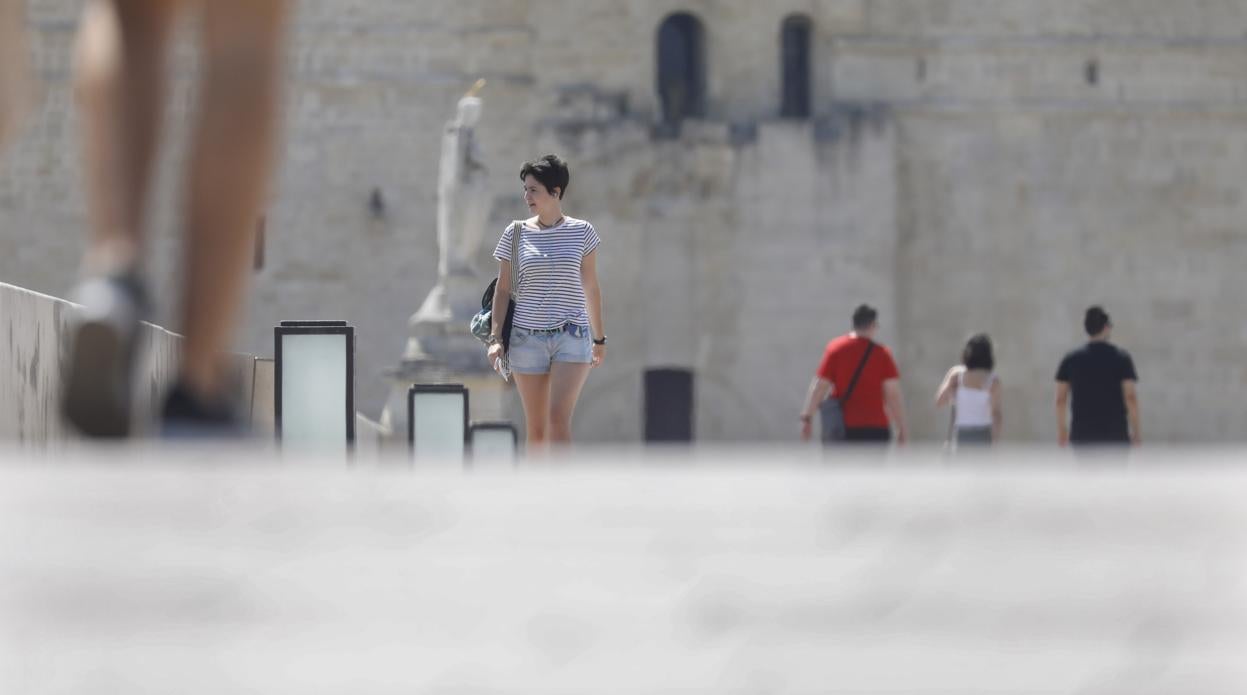 Una turista pasa el Puente Romano, ayer