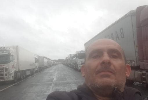 Rafael fotografía la hilera de camiones apostados en la autovía donde se encuentra