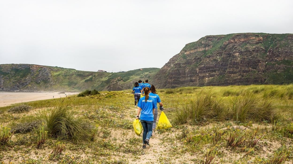 Voluntarios durante la limpieza de una zona verde organizada por Decathlon