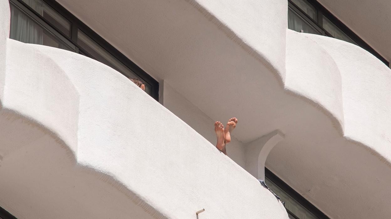 Un estudiante muestra su pies en un balcón durante el confinamiento en Palma del Mallorca