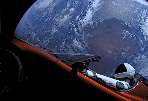 Un automóvil Tesla Roadster rojo cereza flota en el espacio después de que fue transportado allí por el Falcon Heavy de SpaceX