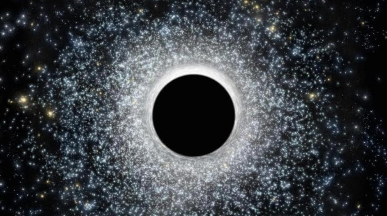 En la ilustración, un agujero negro de masa intermedia rodeado de estrellas. Los astrónomos los buscan en nuestra galaxia