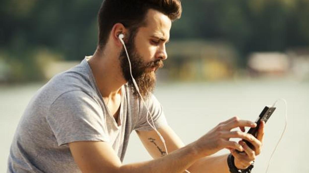 Un joven escucha música a través del móvil