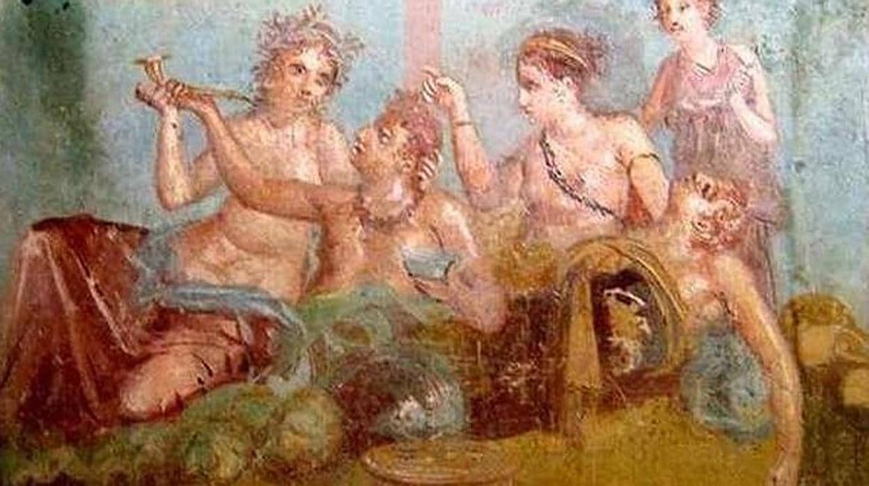 Uno de los frescos de Pompeya, donde varias figuras aparecen en un banquete