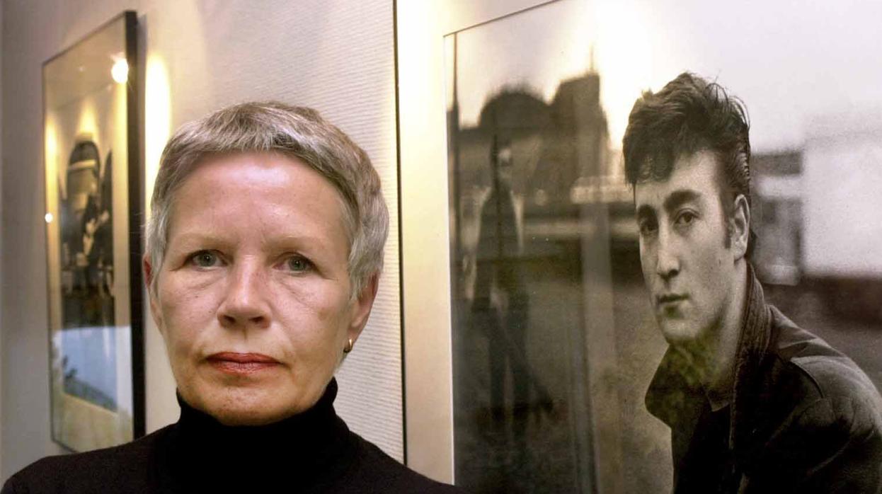 Astrid Kirchherr posa junto a una de las fotografías que le hizo a John Lennon