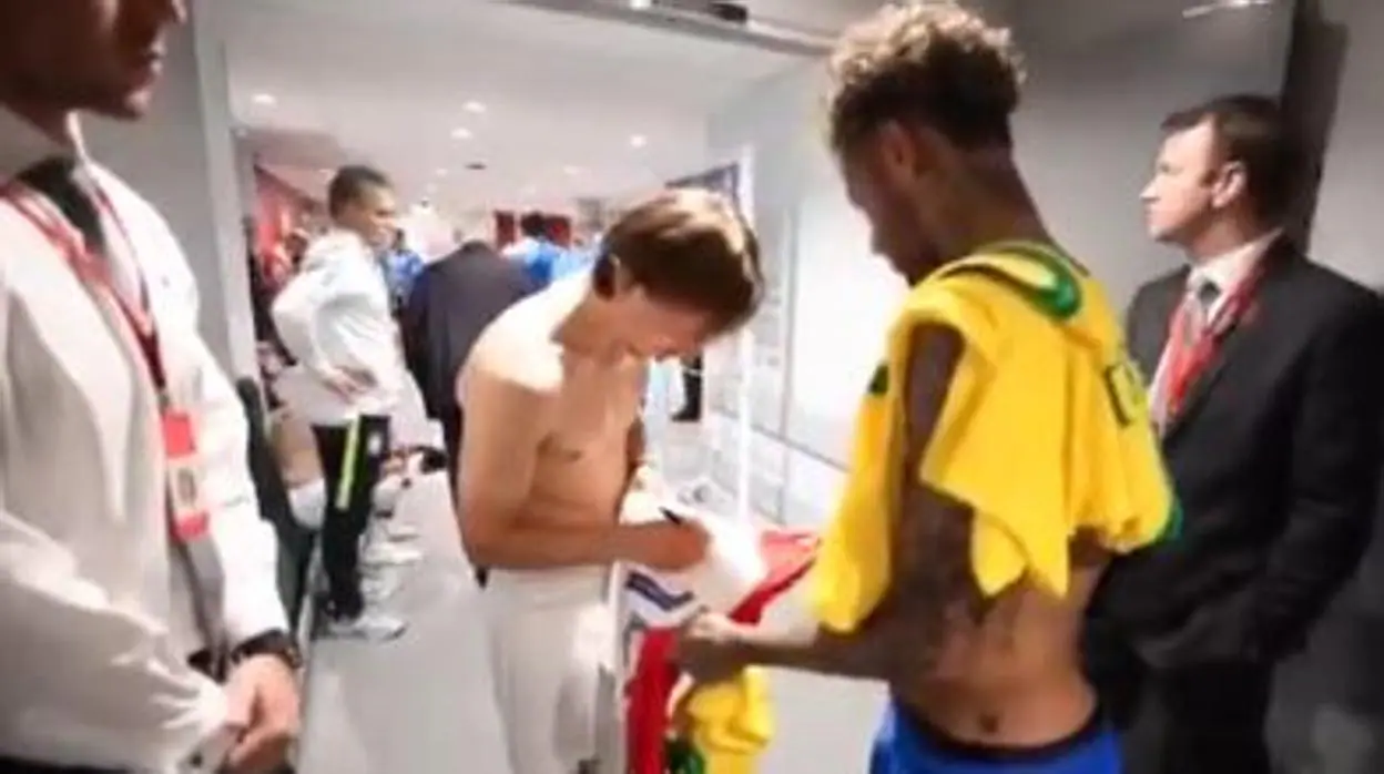 El centrocampista croata Luka Modric firma su camiseta para entregársela a Neymar