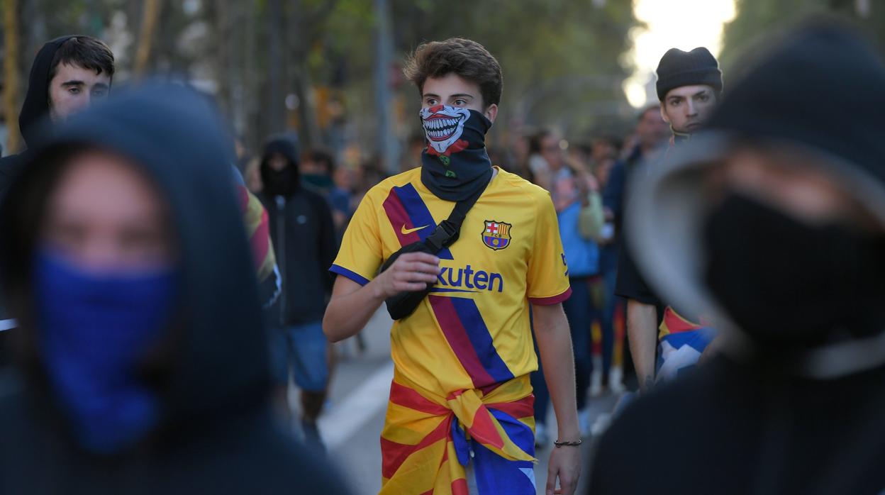 Un manifestante con la cara cubierta y la camiseta del Barça