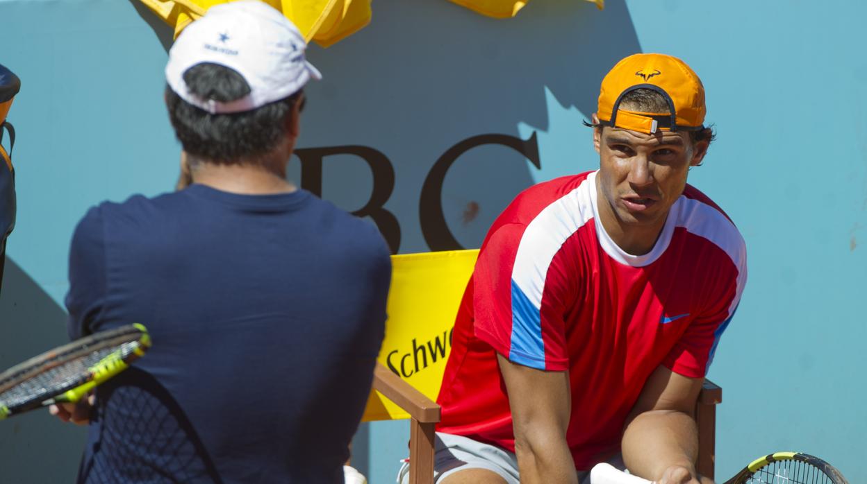 Toni Nadal, de espaldas, conversa con su sobrino Rafael en 2017