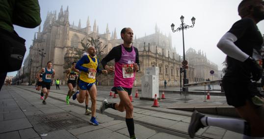 Un paricipante del 25º Media Maratón de Sevilla, pasando la Catedral