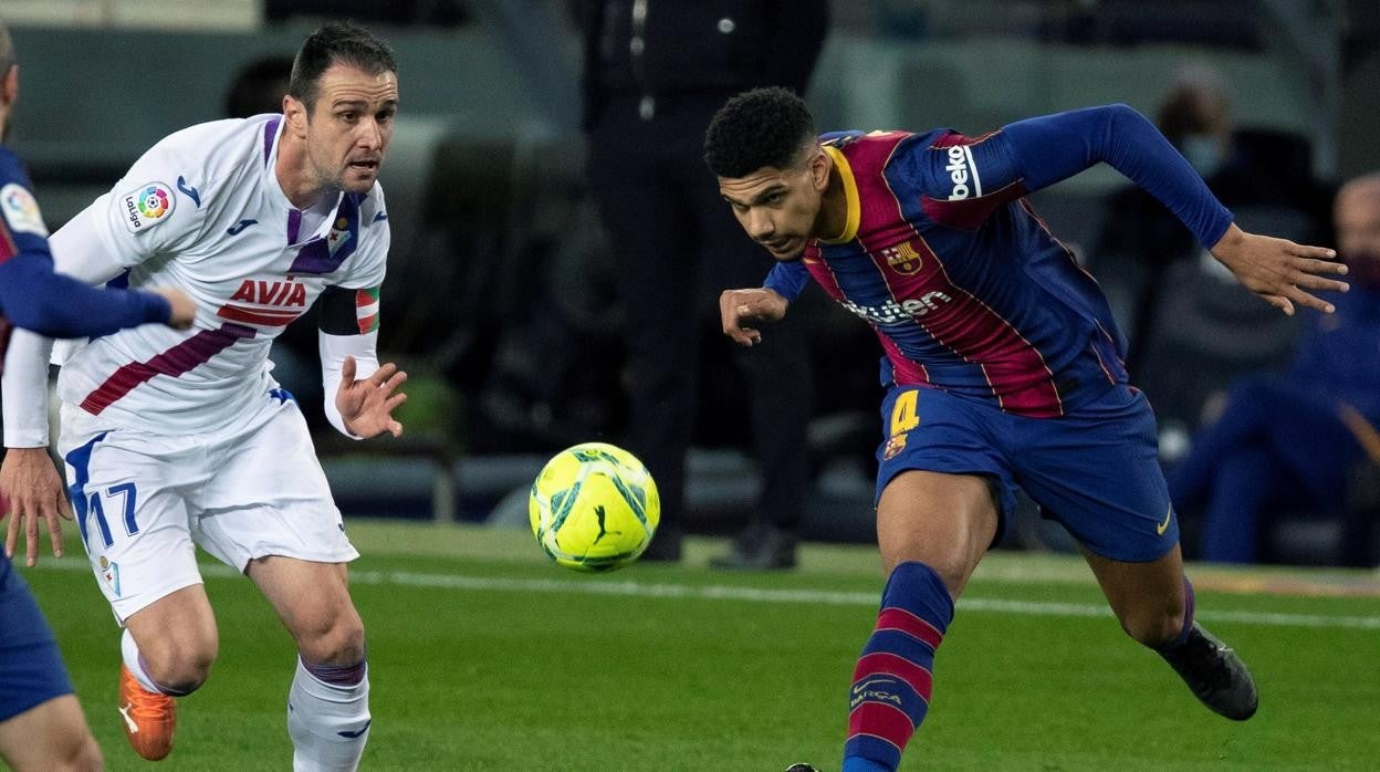 Araújo remata ante Kike García durante el partido entre el Barcelona y el Eibar