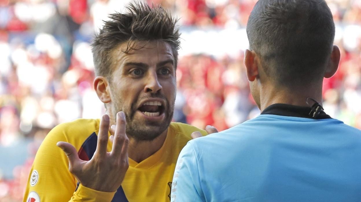 Piqué discute con un árbitro durante un partido