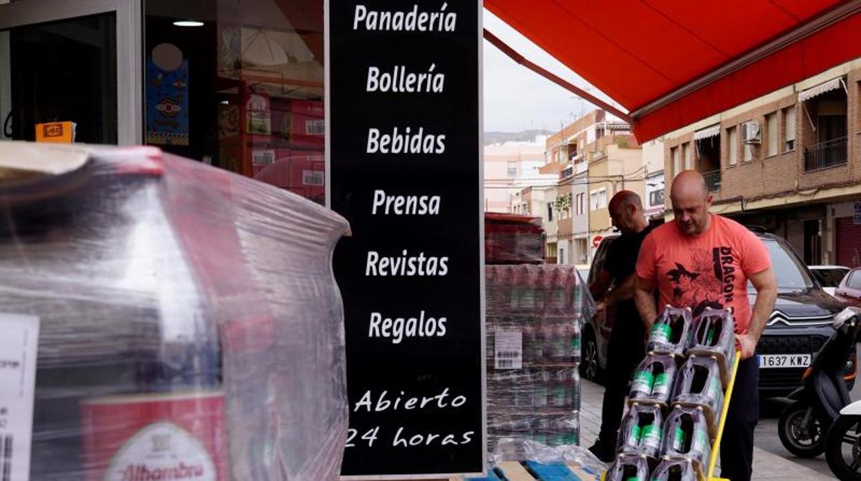 Reposición de cervezas en una tienda de alimentación durante la cuarentena