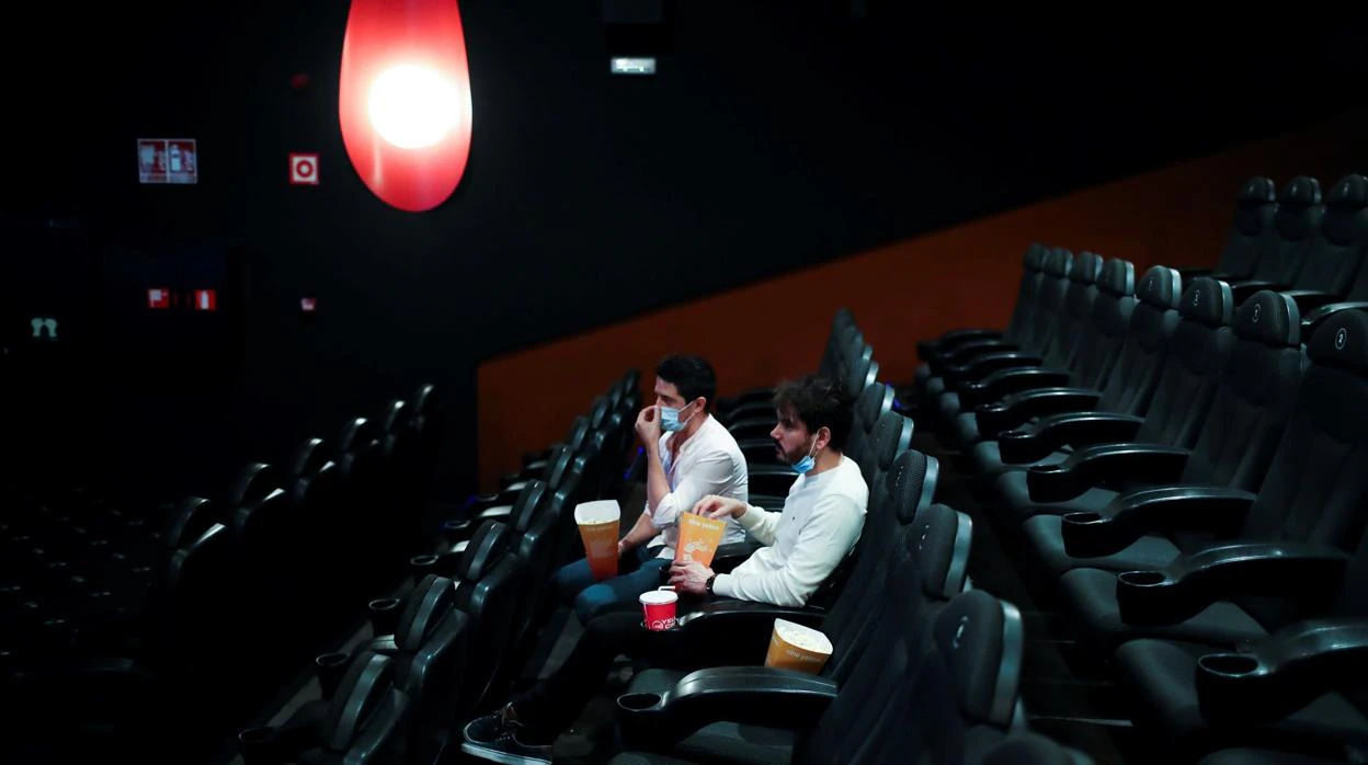 Dos espectadores en una sala de cine semivacía