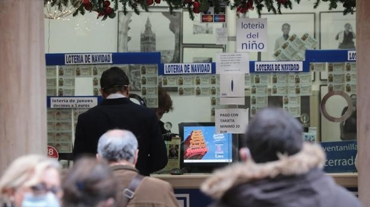 Una persona compra un décimo de la Lotería de Navidad